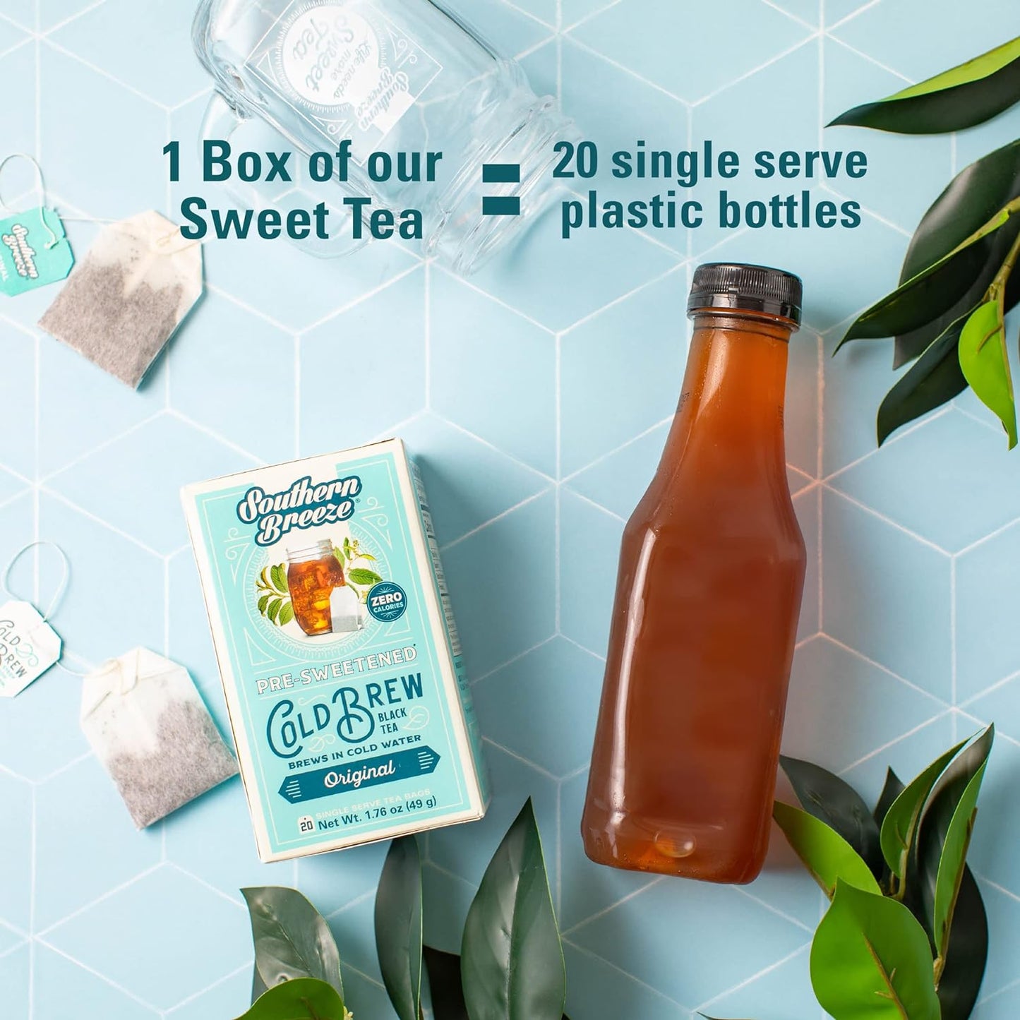 Savies decaf cold brew tea bags box with brewed tea bottle and tea bags on blue tiled surface